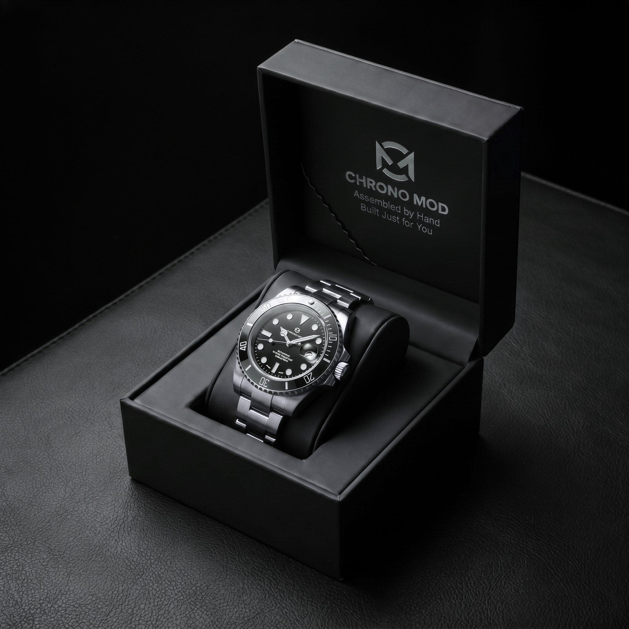 Black submariner Chrono Mod watch in its branded box on black leather